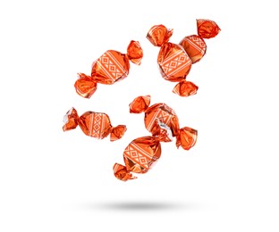 Image of Candies in bright wrappers falling on white background