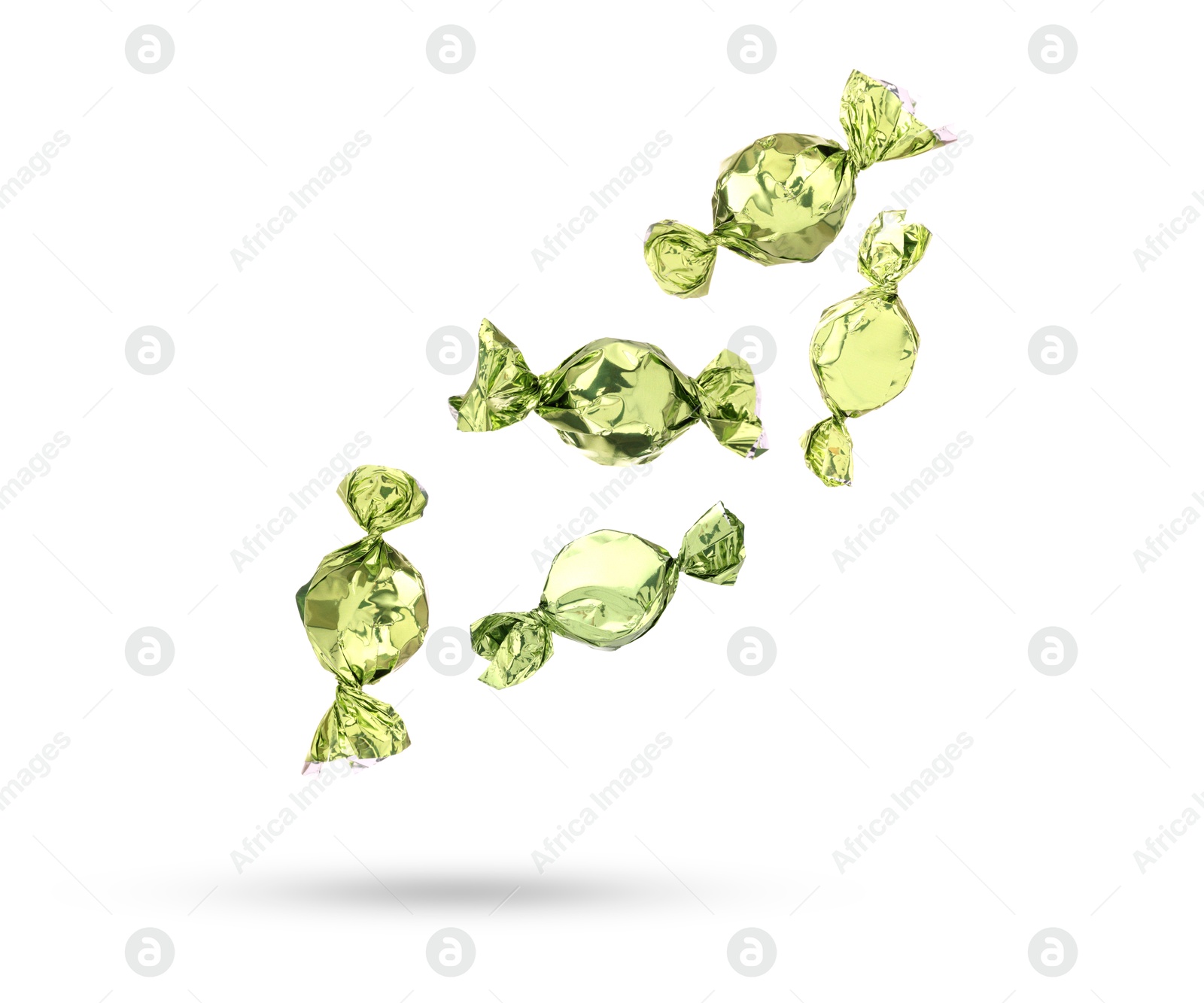 Image of Candies in bright wrappers falling on white background