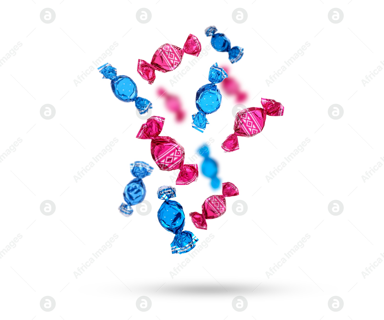 Image of Candies in bright wrappers falling on white background