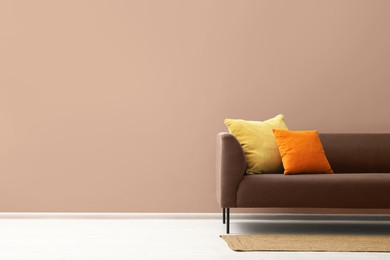 Image of Stylish interior in mocha mousse shade. Sofa and wall in trendy color of 2025 year