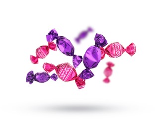 Image of Candies in bright wrappers falling on white background