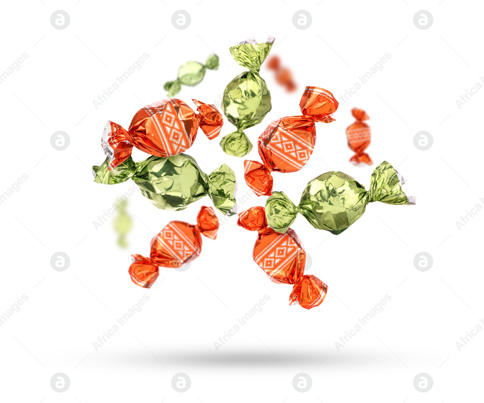 Image of Candies in bright wrappers falling on white background