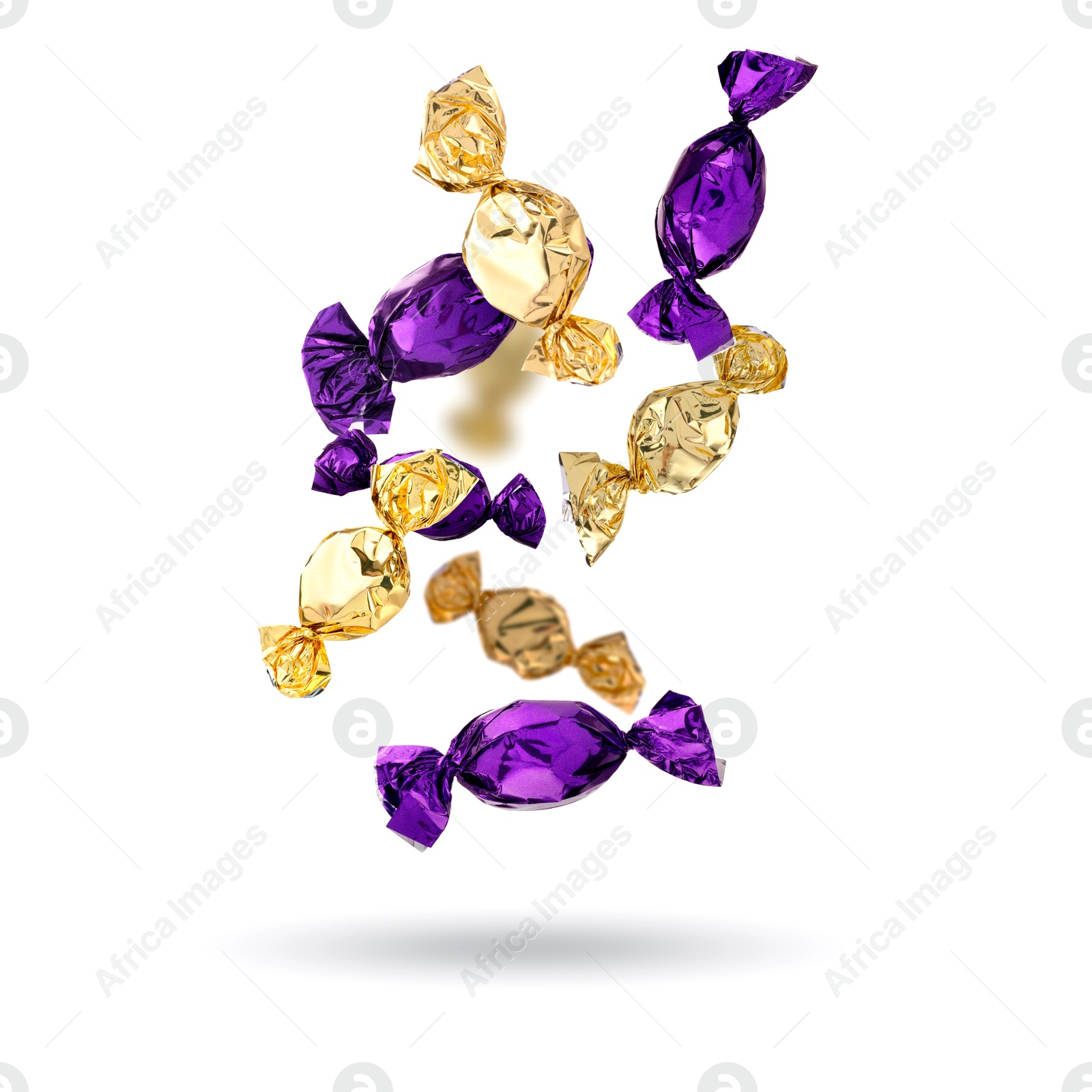 Image of Candies in bright wrappers falling on white background