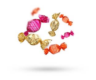 Image of Candies in bright wrappers falling on white background