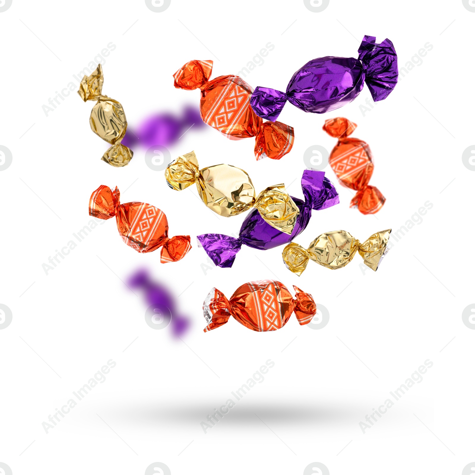 Image of Candies in bright wrappers falling on white background