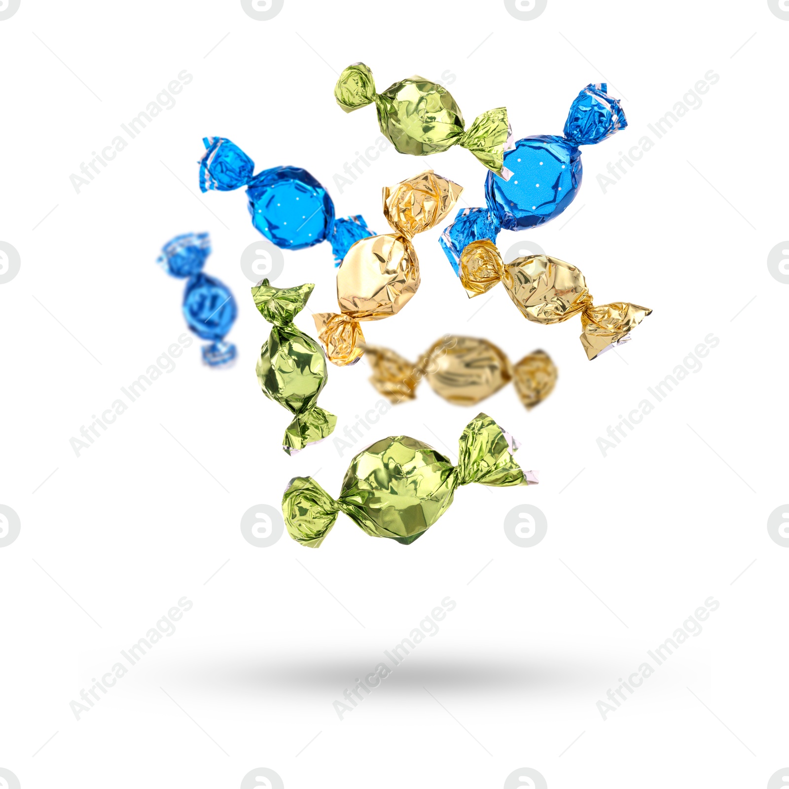 Image of Candies in bright wrappers falling on white background