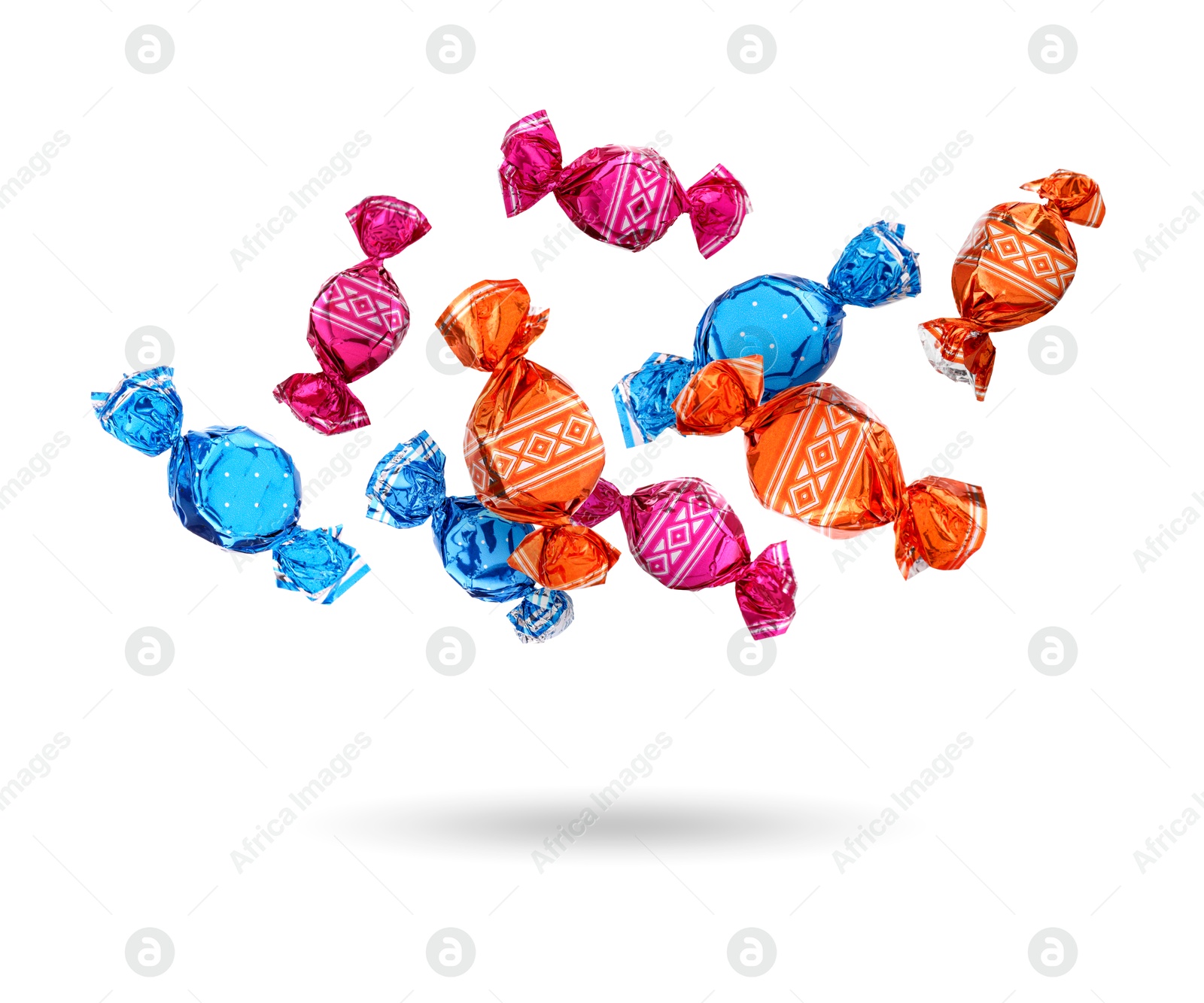 Image of Candies in bright wrappers falling on white background