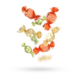 Image of Candies in bright wrappers falling on white background