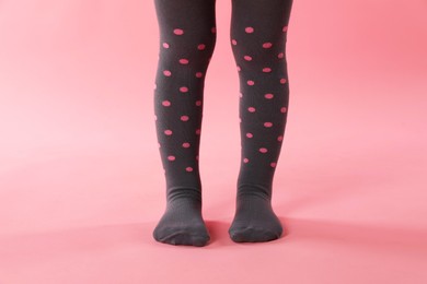 Photo of Child wearing tights on pink background, closeup