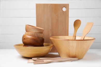 Photo of Dishware and cooking utensils on white table