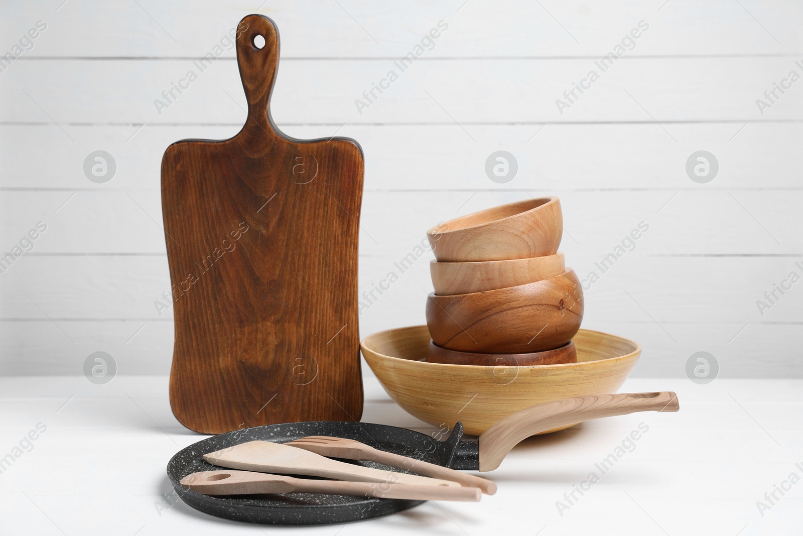 Photo of Dishware and cooking utensils on white table