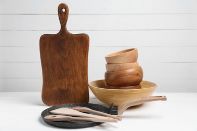 Photo of Dishware and cooking utensils on white table