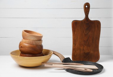 Photo of Dishware and cooking utensils on white table