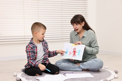 Photo of Therapist working with little boy in autism treatment center