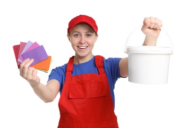 Photo of Professional painter with color samples and bucket of paint on white background