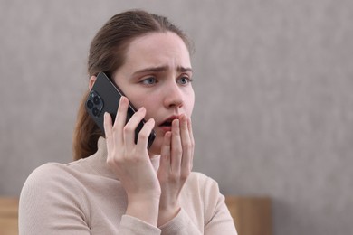 Photo of Stressed woman calling hotline for mental health help at home