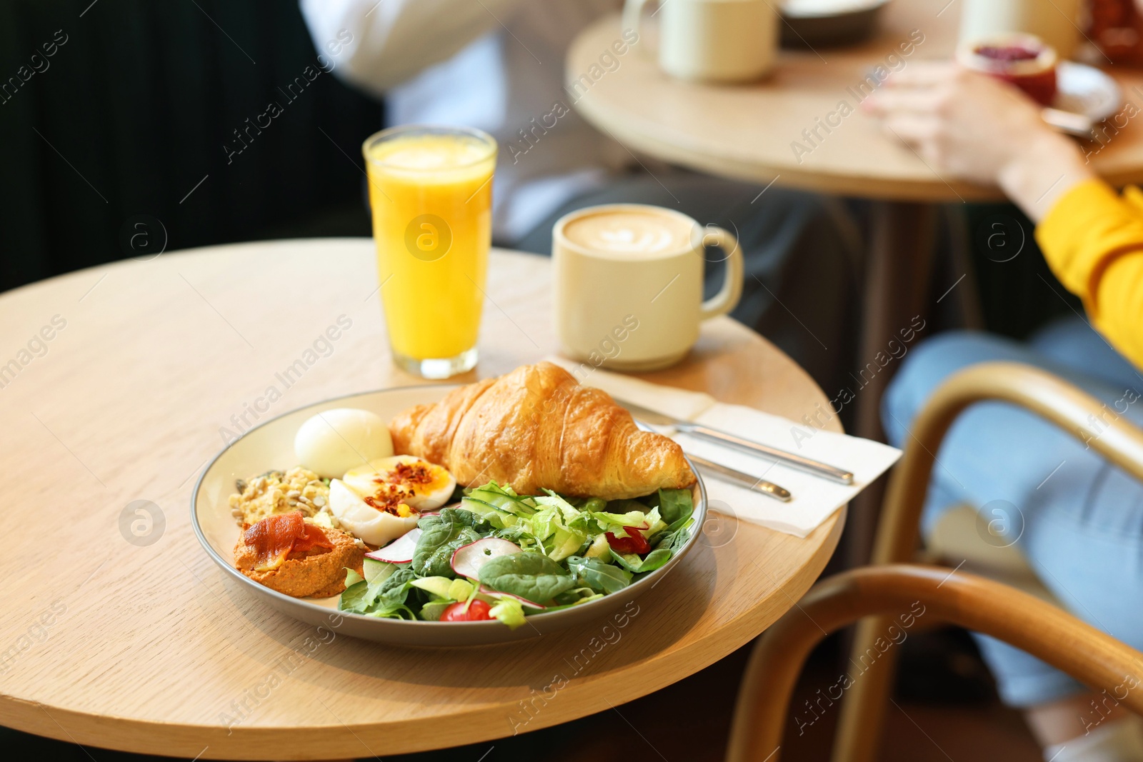 Photo of Women having tasty breakfast in cafe, selective focus