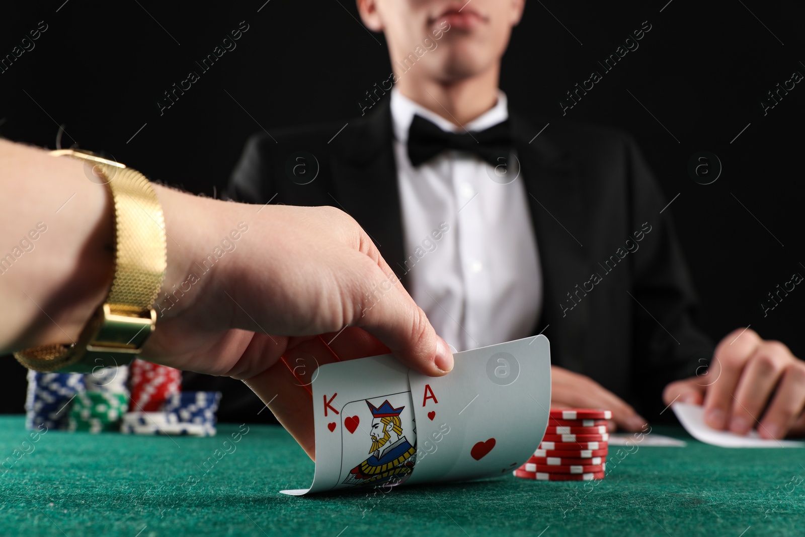 Photo of People playing poker with cards and casino chips at gambling table, closeup