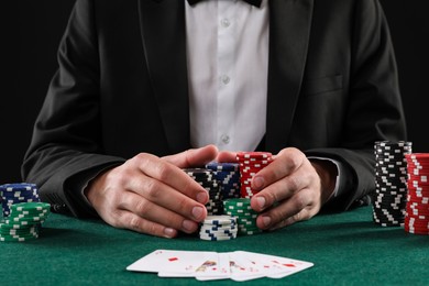 Photo of Man with cards and casino chips playing poker at gambling table, closeup