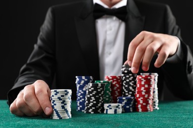 Photo of Man with casino chips playing poker at gambling table, closeup