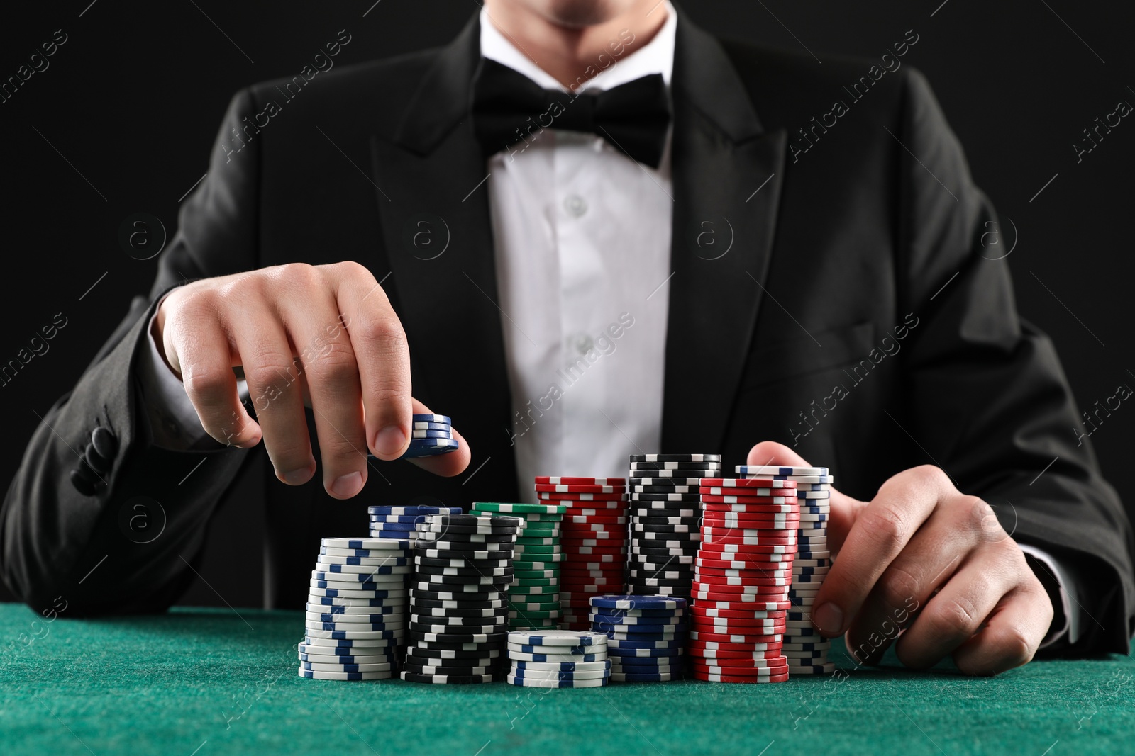 Photo of Man with casino chips playing poker at gambling table, closeup