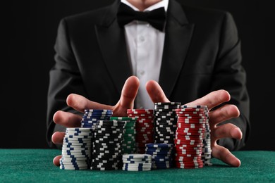 Photo of Man with casino chips playing poker at gambling table, closeup