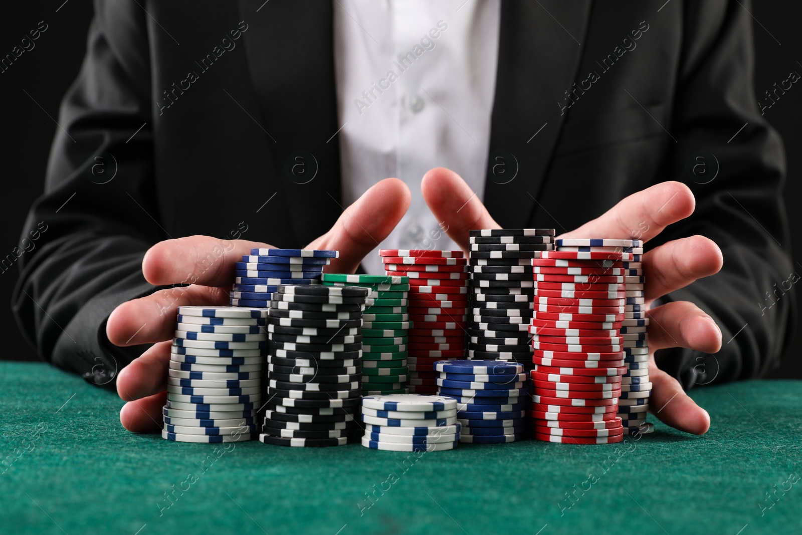 Photo of Man with casino chips playing poker at gambling table, closeup