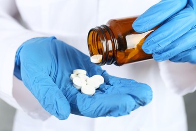 Photo of Doctor with bottle of antibiotic pills, closeup