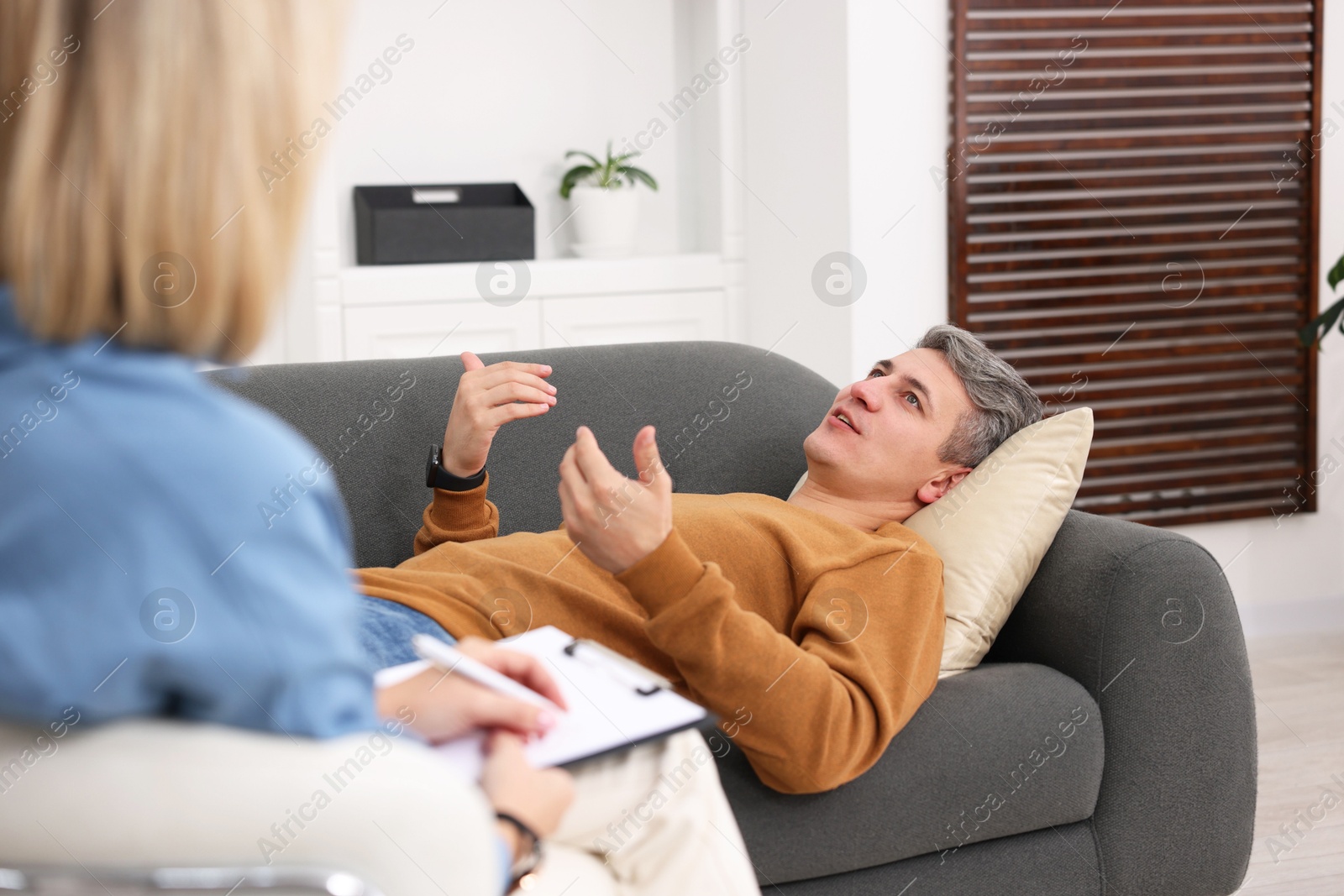 Photo of Professional psychologist working with patient in office, closeup