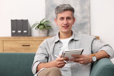 Photo of Portrait of professional psychologist with notebook in office