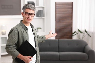 Photo of Portrait of professional psychologist with clipboard in office, space for text