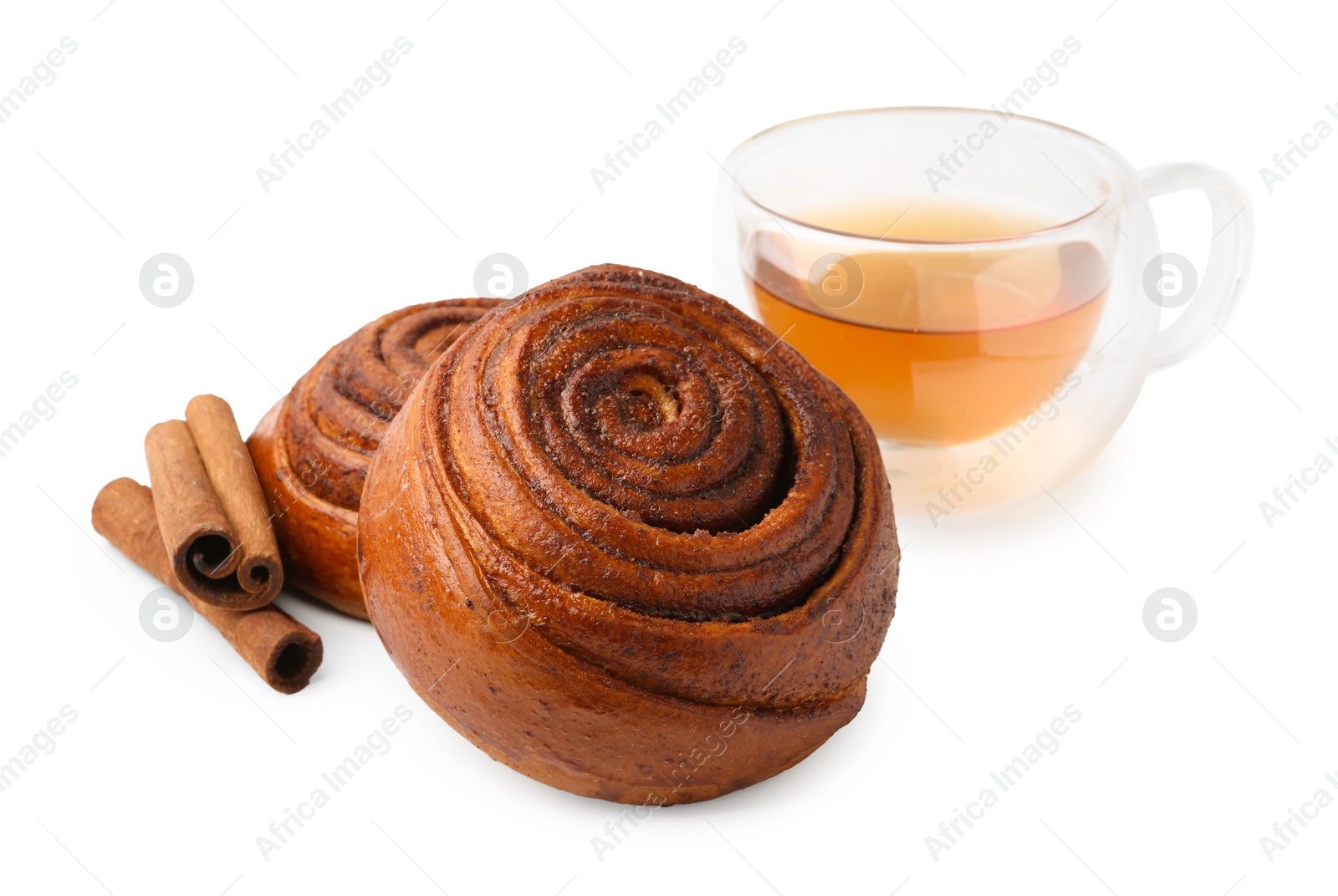 Photo of Delicious cinnamon roll buns with tea and spices isolated on white