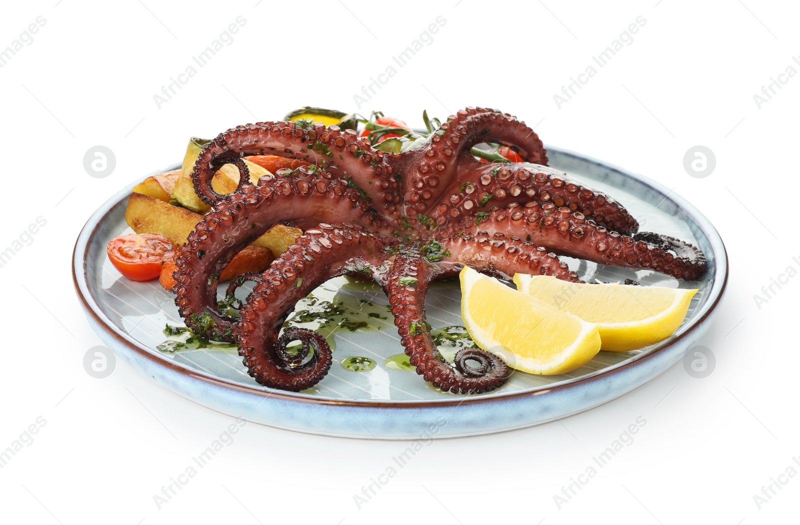 Photo of Fried octopus with herb sauce, lemon and vegetables isolated on white