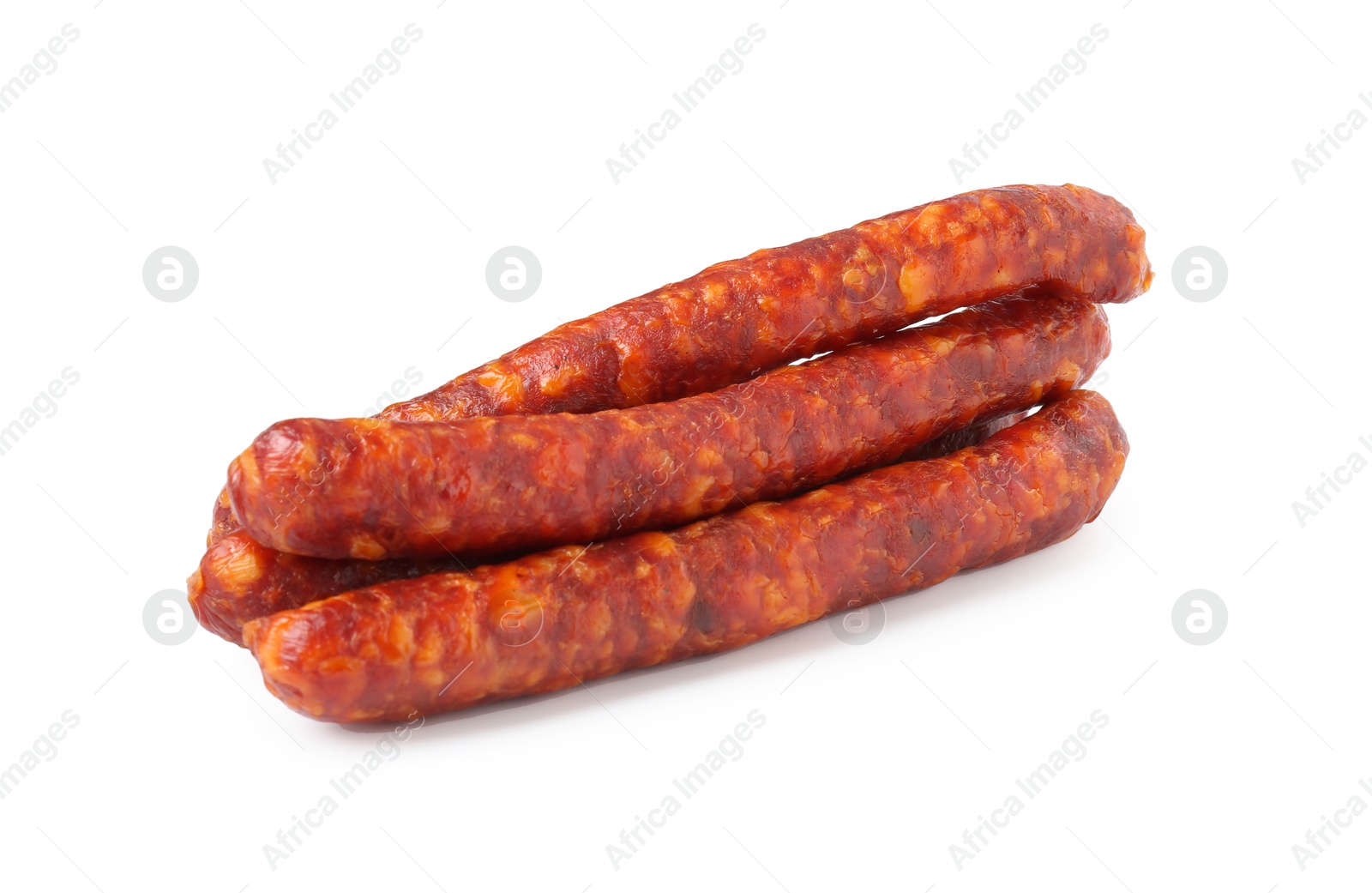 Photo of Many thin dry cured sausages isolated on white