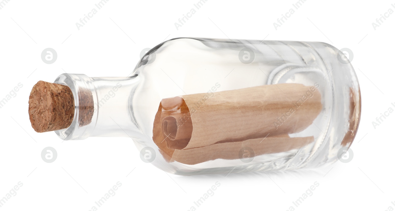 Photo of Corked glass bottle with rolled letter isolated on white