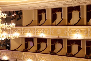 Photo of Balconies with comfortable chairs and vintage lamps in theatre