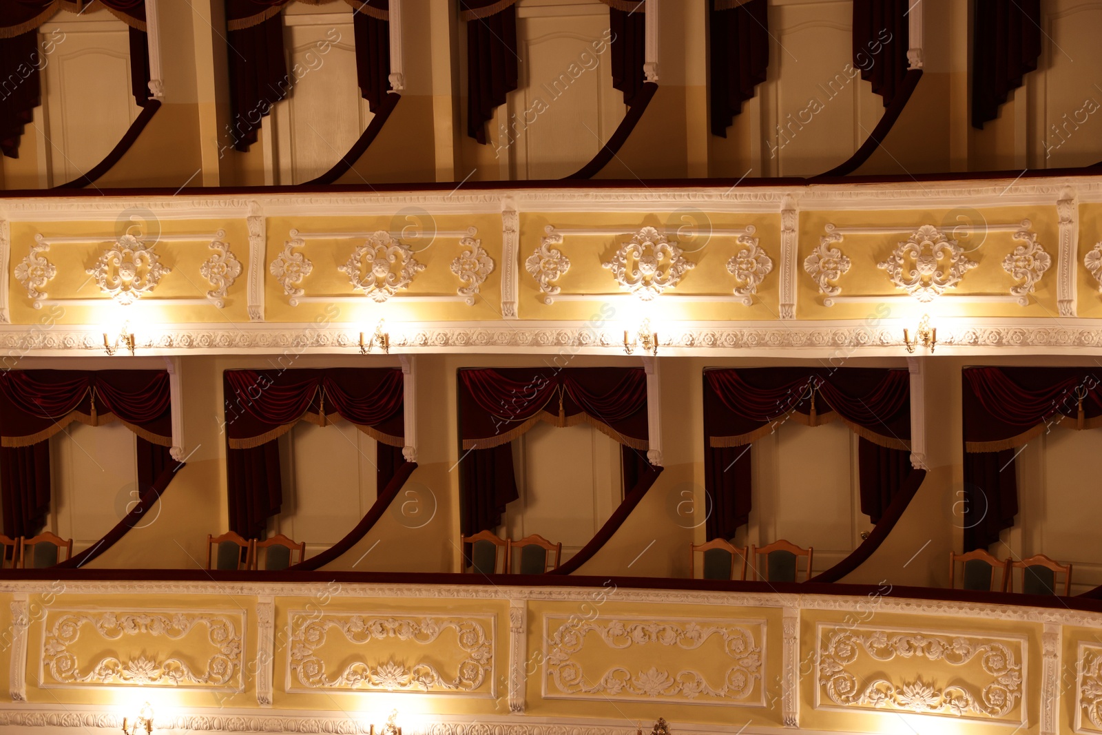 Photo of Balconies with comfortable chairs and vintage lamps in theatre