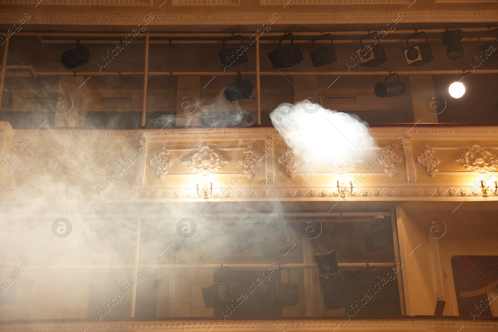 Photo of Professional spotlights and smoke in theatre, low angle view