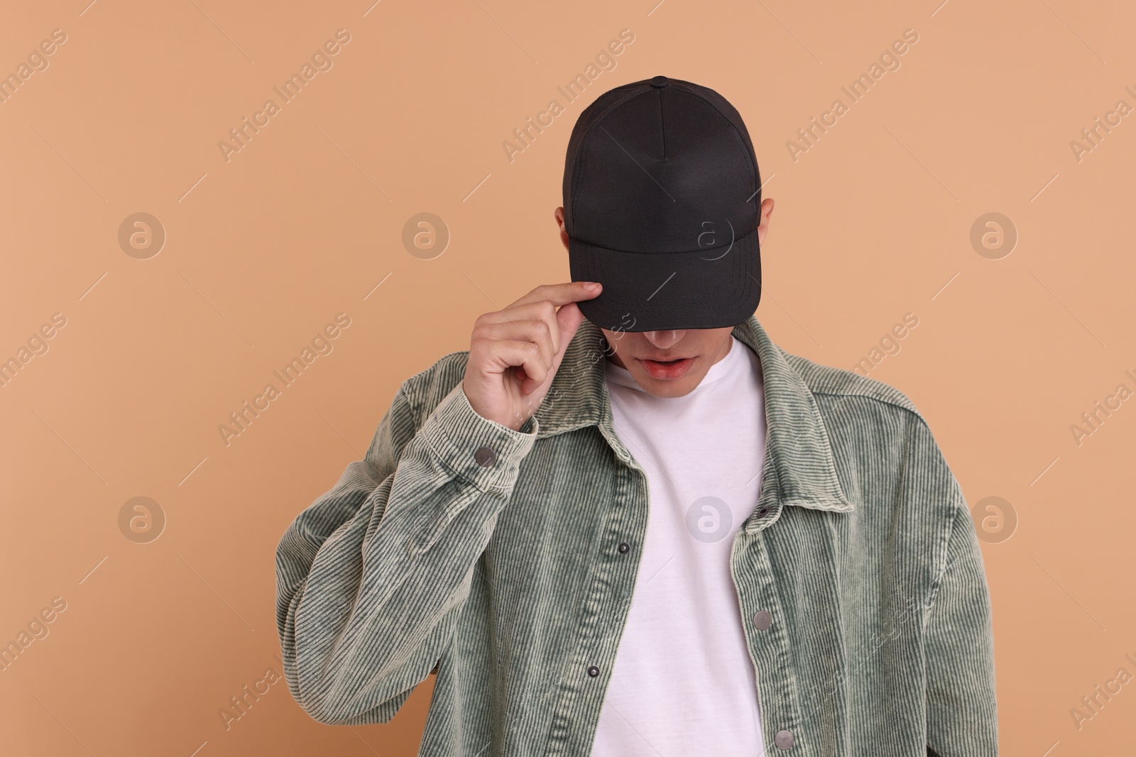 Photo of Man in stylish baseball cap on beige background. Mockup for design