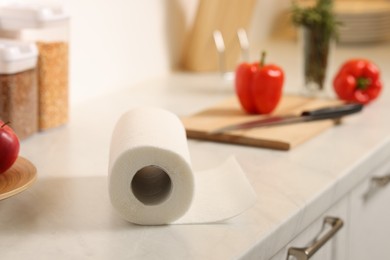 Photo of Roll of paper towels on white marble countertop in kitchen, closeup