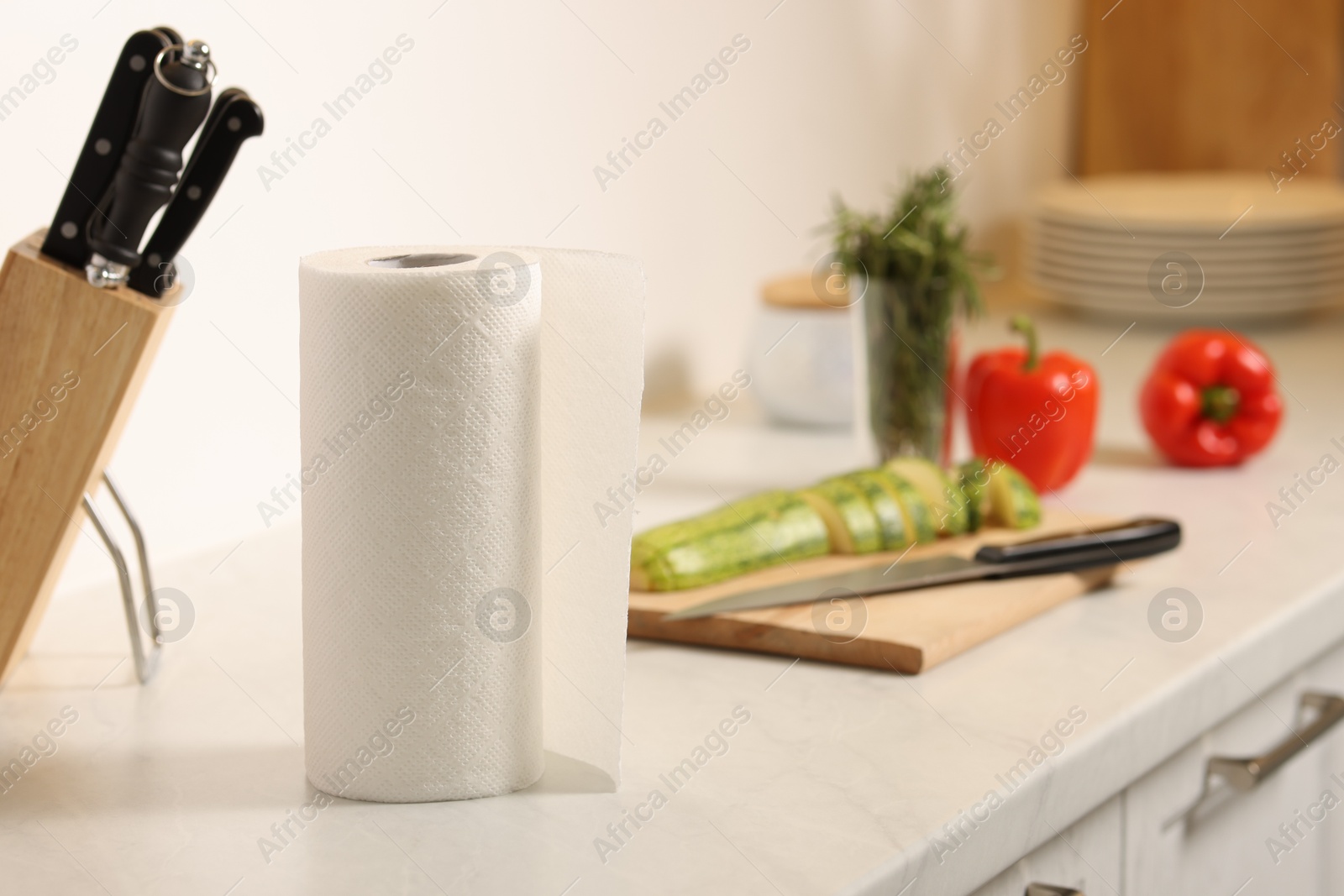 Photo of Roll of paper towels on white marble countertop in kitchen