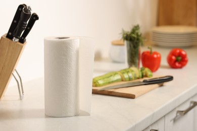 Photo of Roll of paper towels on white marble countertop in kitchen