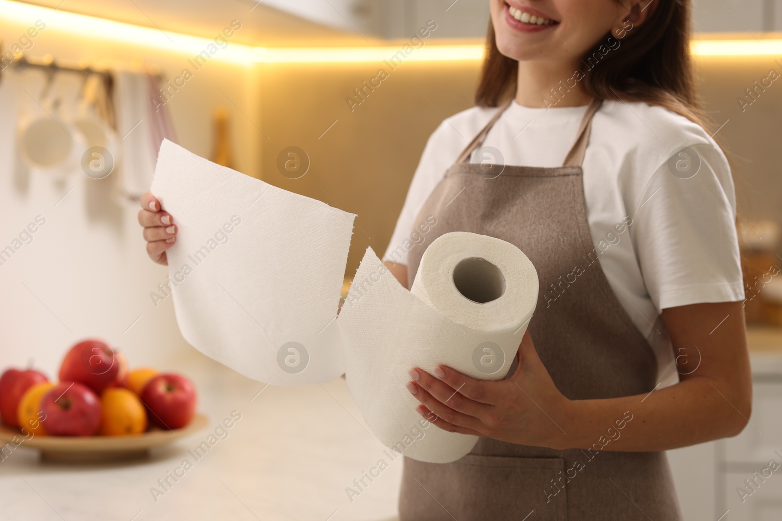 Photo of Woman using paper towels in kitchen, closeup