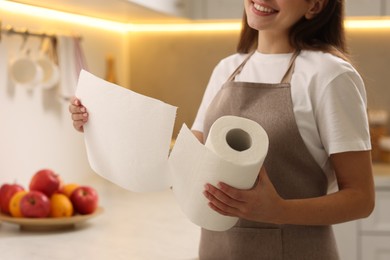 Photo of Woman using paper towels in kitchen, closeup