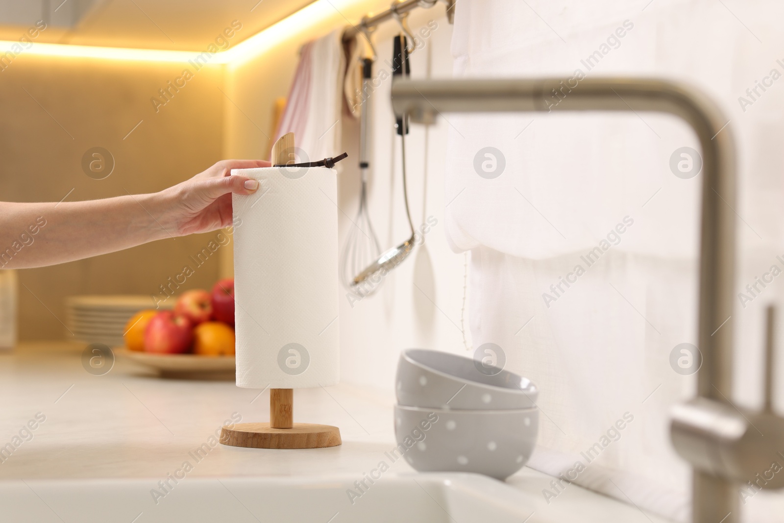 Photo of Woman using paper towels in kitchen, closeup