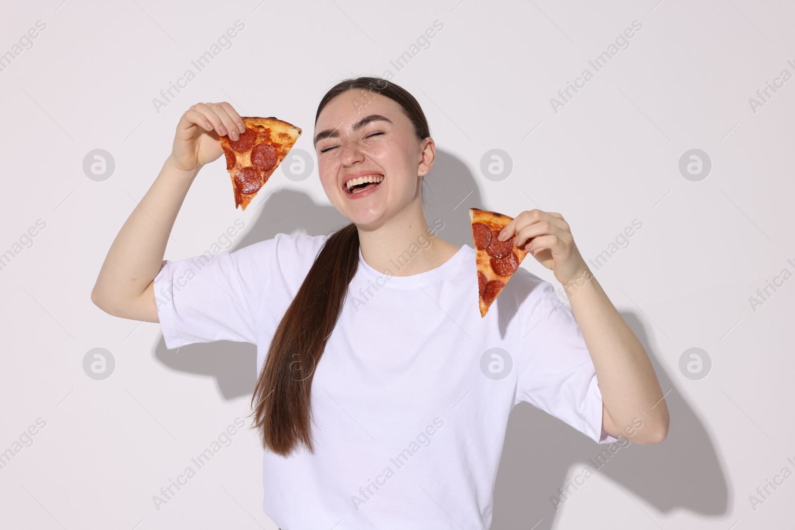 Photo of Beautiful woman with delicious pizza on white background