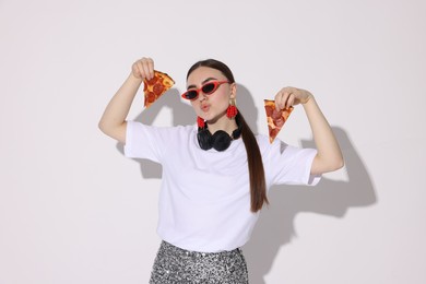 Photo of Woman in sunglasses with delicious pizza on white background