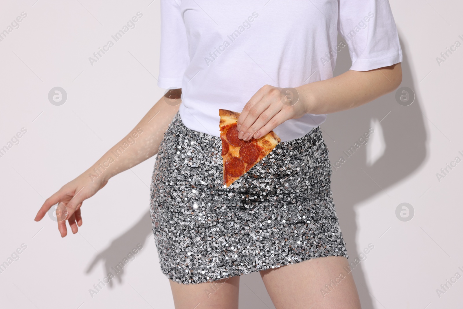 Photo of Woman with piece of pizza on white background, closeup