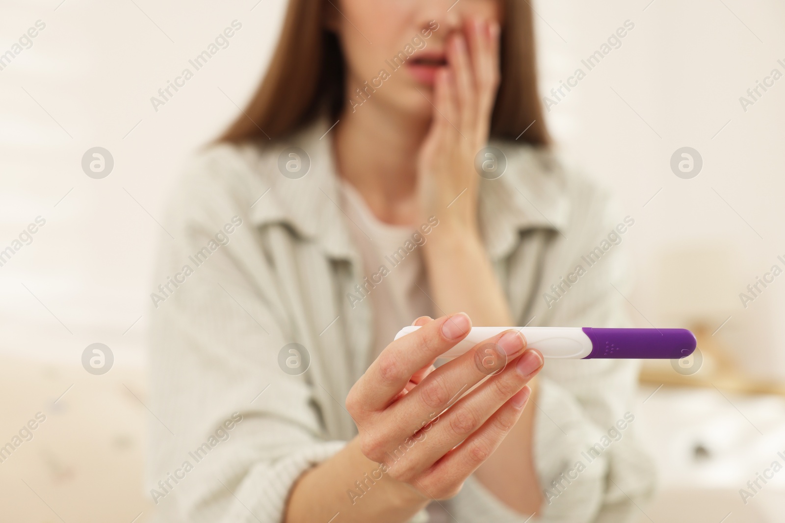 Photo of Woman with negative pregnancy test at home, closeup