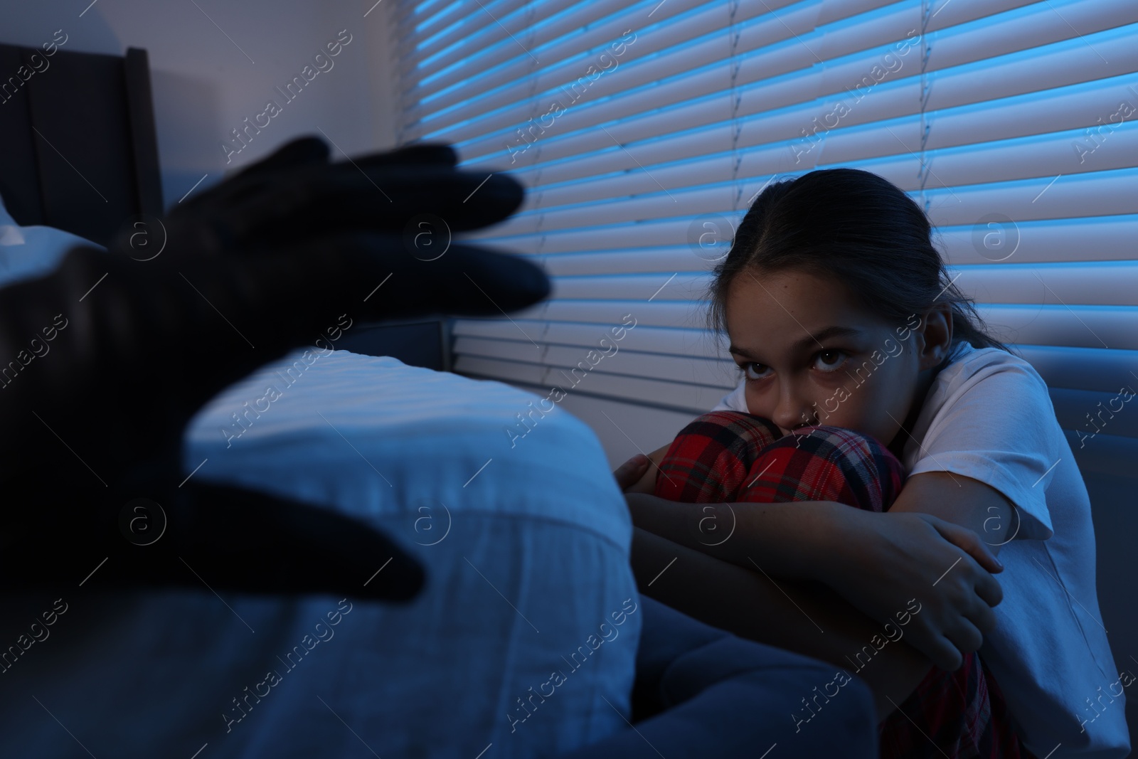 Photo of Bogeymen reaching for scared girl in bedroom at night, closeup